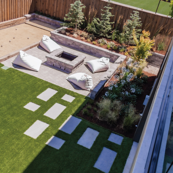 View from deck down to outdoor fire pit and backyard of a custom home built by Mike Riddle Construction