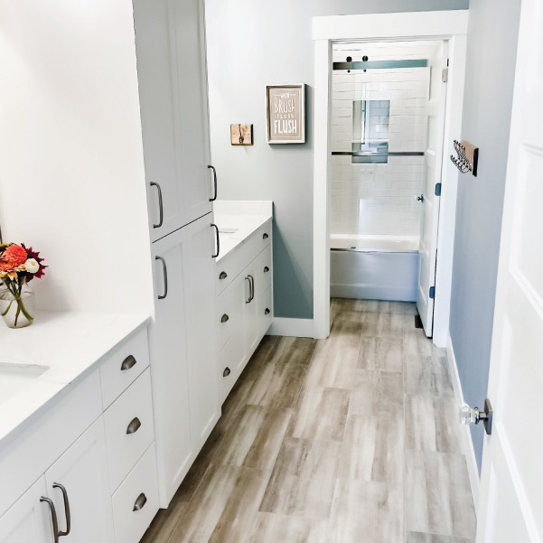 A farmhouse bathroom with two sinks and private shower