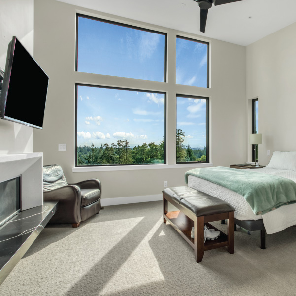 View into a bedroom with asymmetrical windows to capture the view built by Mike Riddle Construction