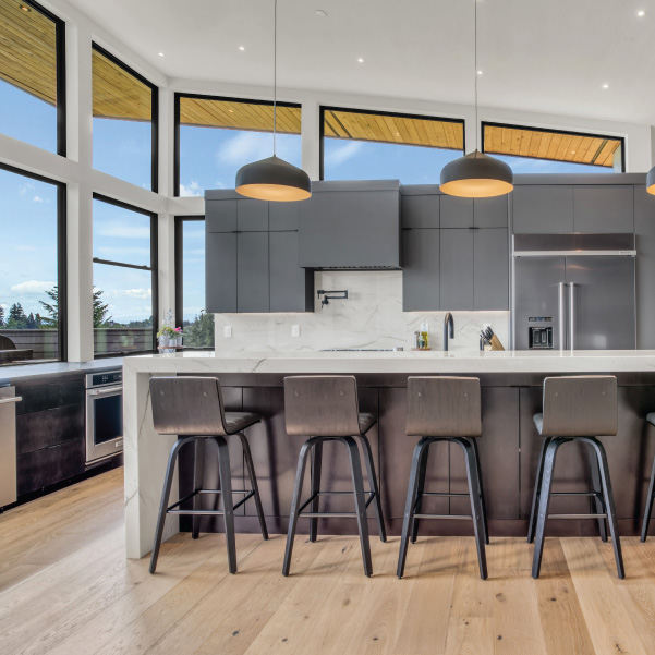 Industrial modern kitchen featuring standalone cabinetry to capture views