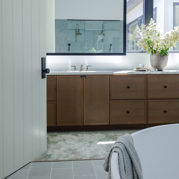 Full-size hanging bathroom mirror over a single sink in a Street of Dreams home built by Mike Riddle Construction