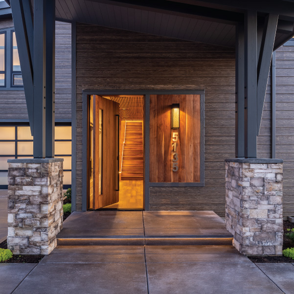 Front door of a modern coastal home with overhead protection