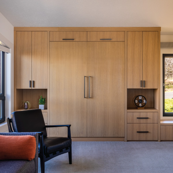 Modern closet doors in a bedroom of a coastal home built by Mike Riddle Construction