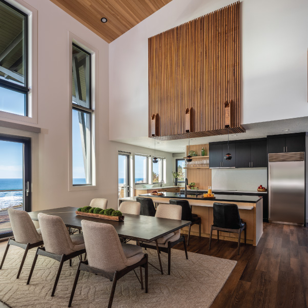 Modern Oregon coast design of a dining area and open concept kitchen built by Mike Riddle Construction