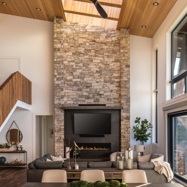 Stone fireplace with TV surround in a living area of an Oregon coast home built by Mike Riddle Construction