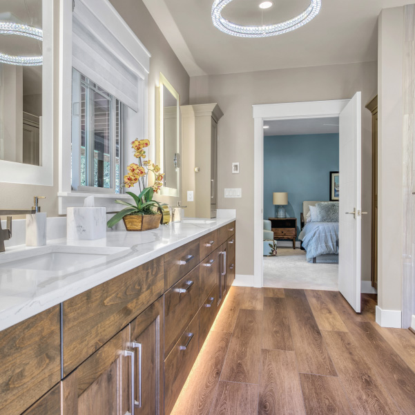 Wall of bathroom cabinets leading to a bedroom in a custom home built by Mike Riddle Construction