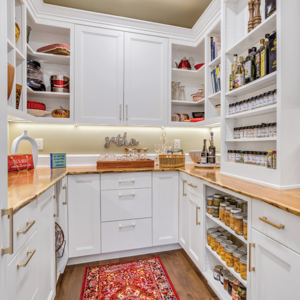 A white walk-in pantry with floor-to-ceiling cabinets in a custom home built by Mike Riddle Construction