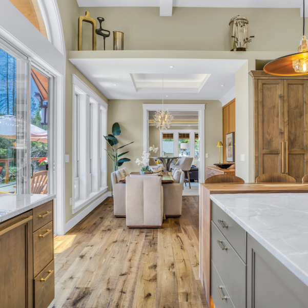 An interior look through the kitchen and dining room of a modern home built by Mike Riddle Construction