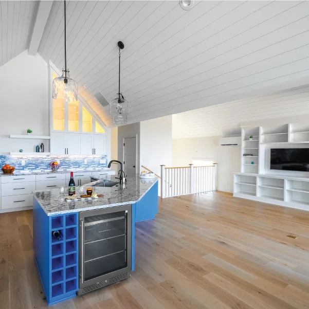 Coastal cottage kitchen with undercounter refrigerator looking into living area